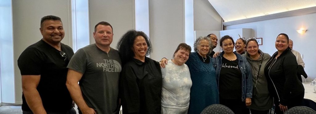 Members of the Ma Mawi Wi Chi Itata Centre delegation pose for a photo with Nan and Katie Murray of Waitomo Papakāinga in Wellington during the whanaungatanga session with E Tū Whānau. 