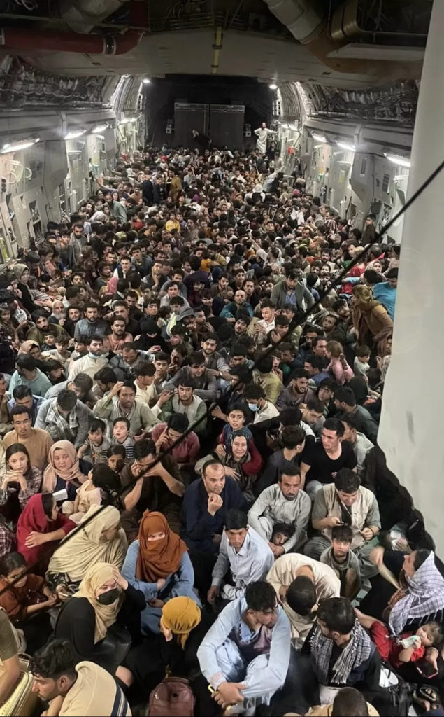 Afghan refugees crowded into an aeroplane leaving Kabul on August 15, 2021