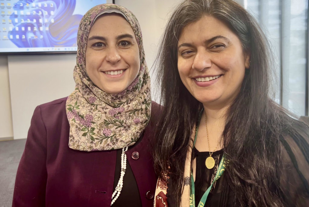 Dr Hend Zaki and Dr Fatima Junai, who presented on the results of their separate research into Muslim Women's experiences of inclusion and discrimination at the 33rd IWCNZ National Conference, smile and pose together for a photo.