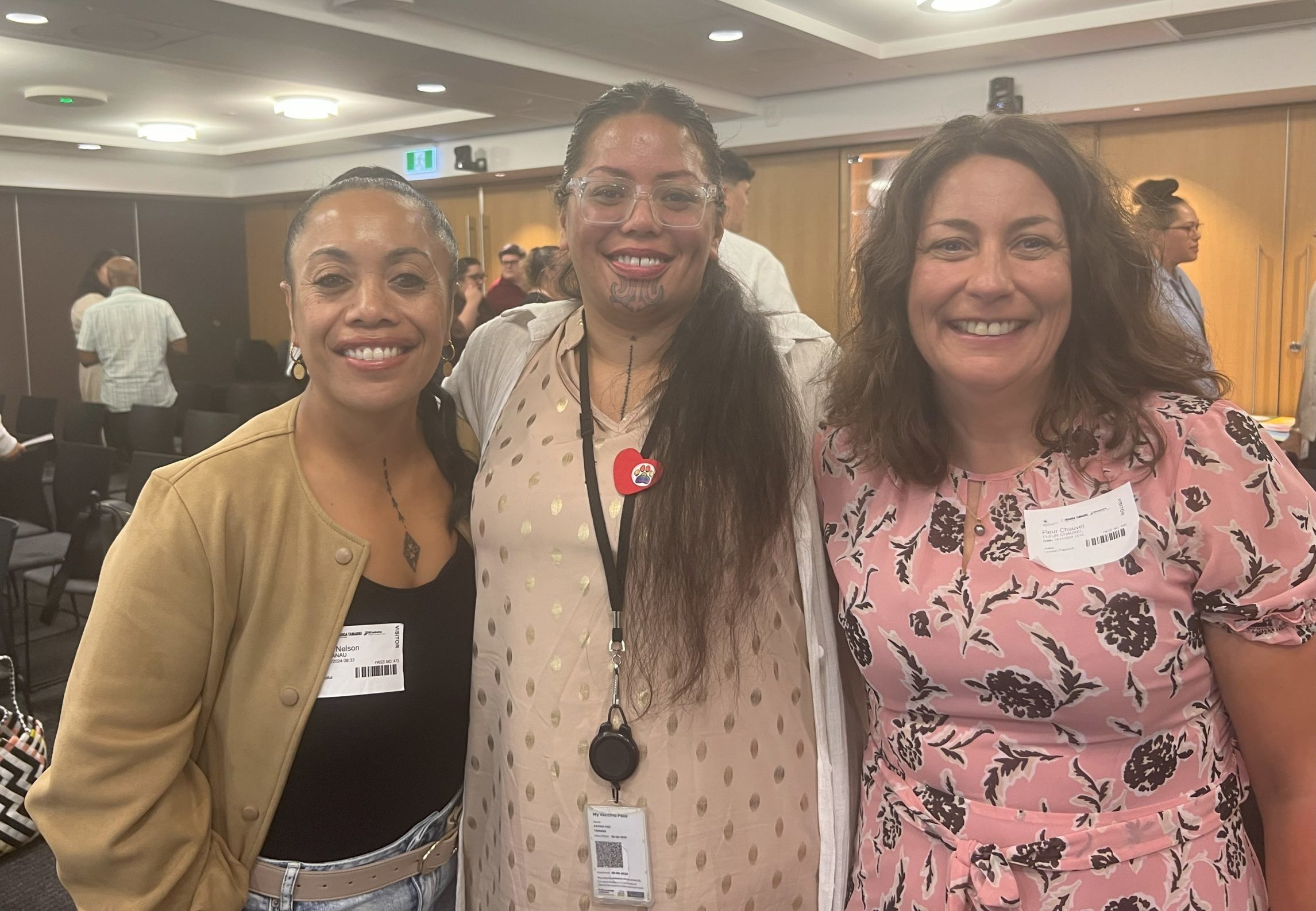 E Tū Whānau kaimahi Swanie Nelson and Tria Tamaka with researcher Fleur Chauvel at the celebration event