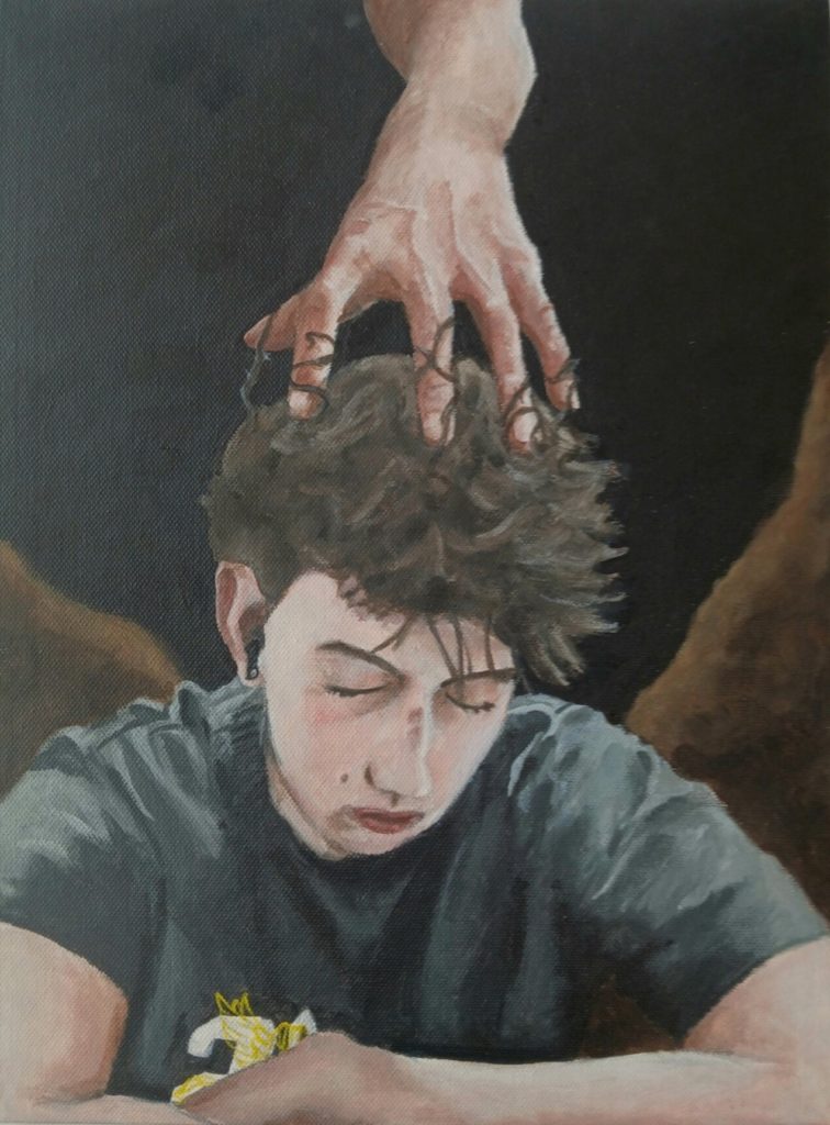 This image is of the poster by James Davis, one of the winners of the E Tū Whānau Poster Competition 2025 (13 t0 18 years category). It depicts a teenage boy dresses in a gray t-shirt. His arms are crossed in front of him. From behind, lurking out of the darkness, a hand with outstretched fingers grasps the top of his head.