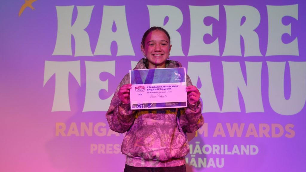 Lila Porteners, Māire Raunui - Rangatahi Leader in Ka Rere te Manu Rangatahi Film Awards 2026 smiles and holds up her winner's certificate.