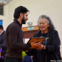 Zaki Ayubu receiving his Rangatahi Kahukura - Emerging Leader award from Katie Murray. They are both smiling .