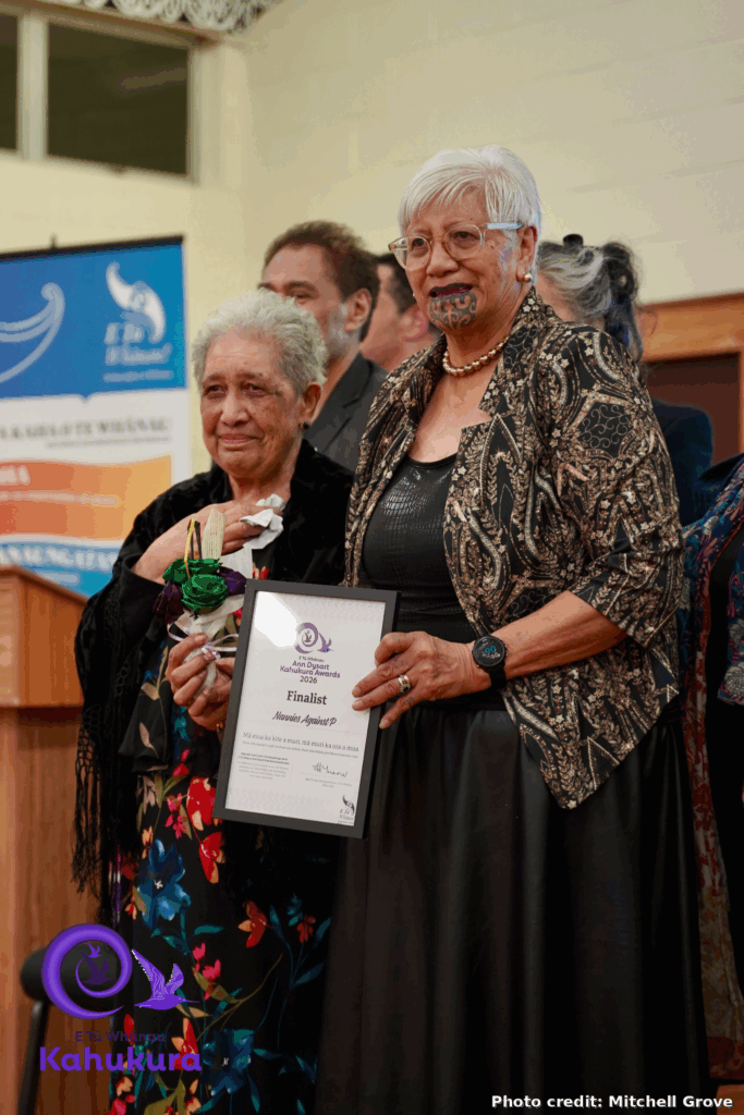Two kui, Lovey Edwards and Ngatiriti King, hold the certificate recognising Nannies Against P as a finalist in the Ann Dysart Kahukura Award 2026. They are both dressed formally, one has a moko kauae