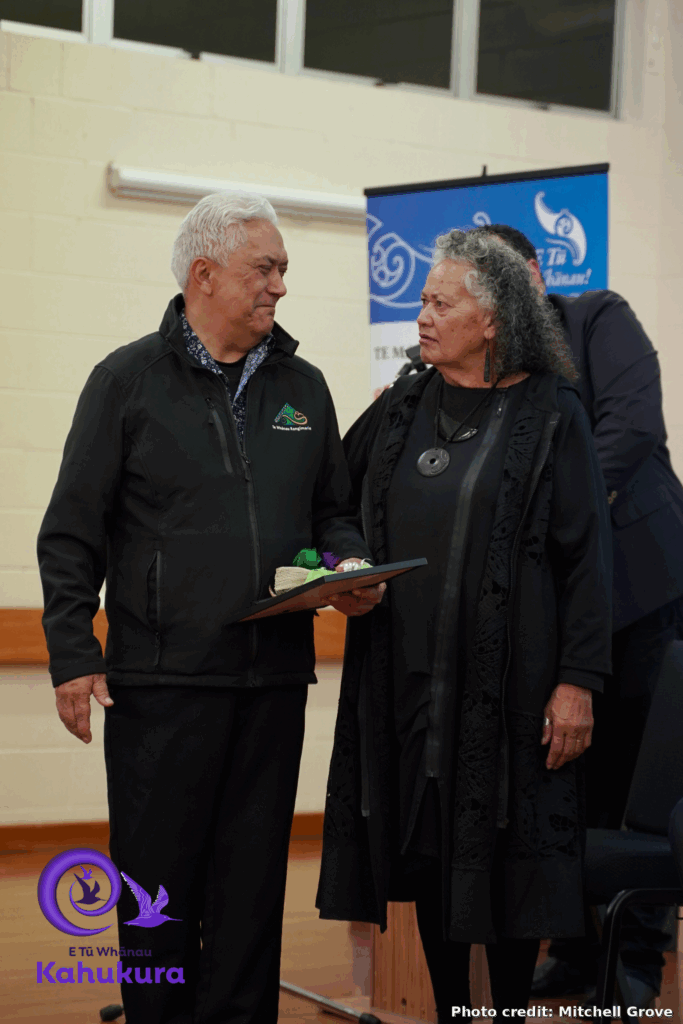 Rima Williams, Te Whānau Rangimarie kaimahi stands talking to Katie Murray at the awards. Both are dressed formally, and Rima holds a certificate.