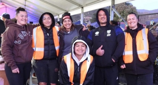 Six young people, including Renee Davies. stand together, some wearing high-vis vests. Some have their arms around each other's shoulders. They are all smiling and looked relaxed.